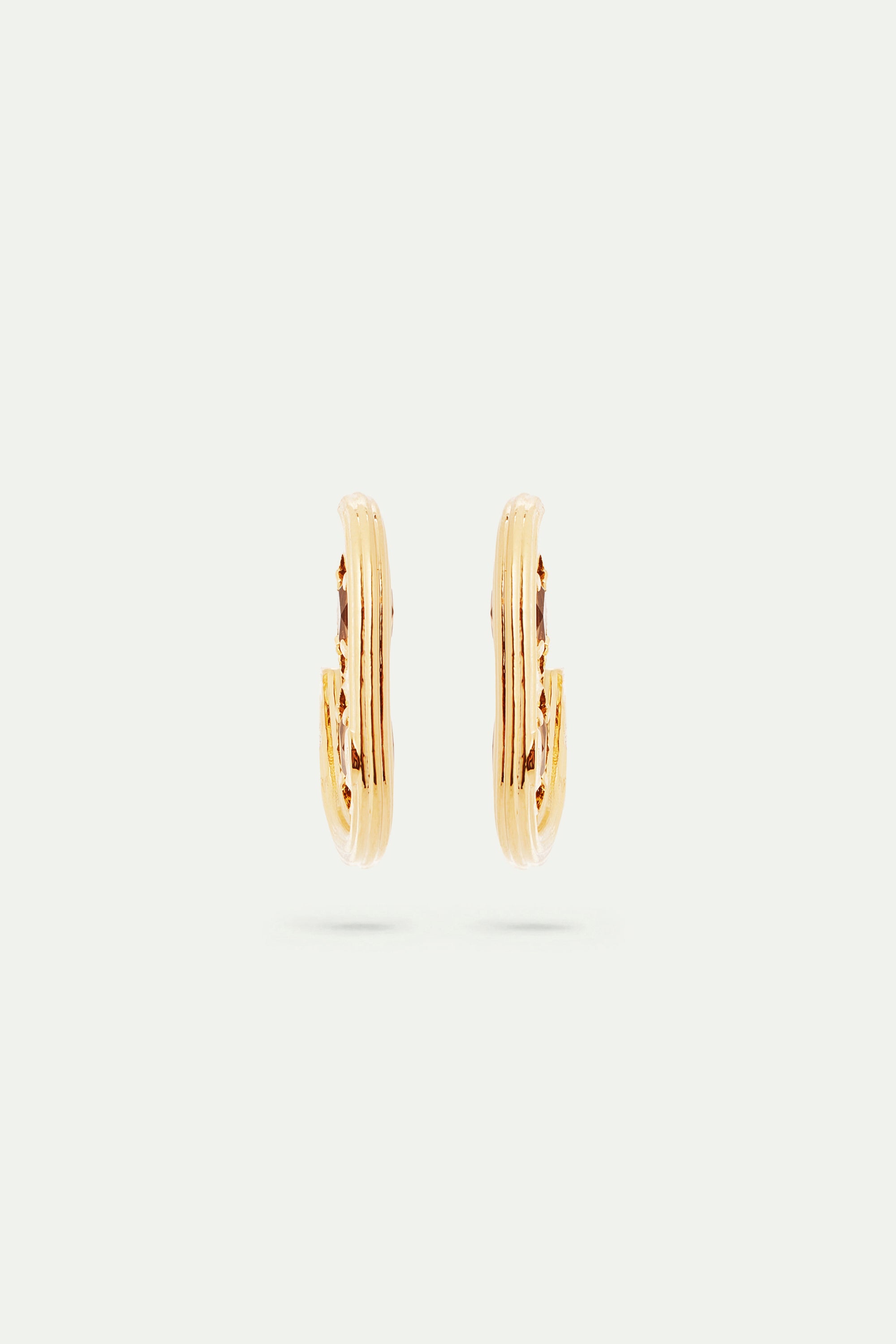 Gold hoop earrings and faceted glass