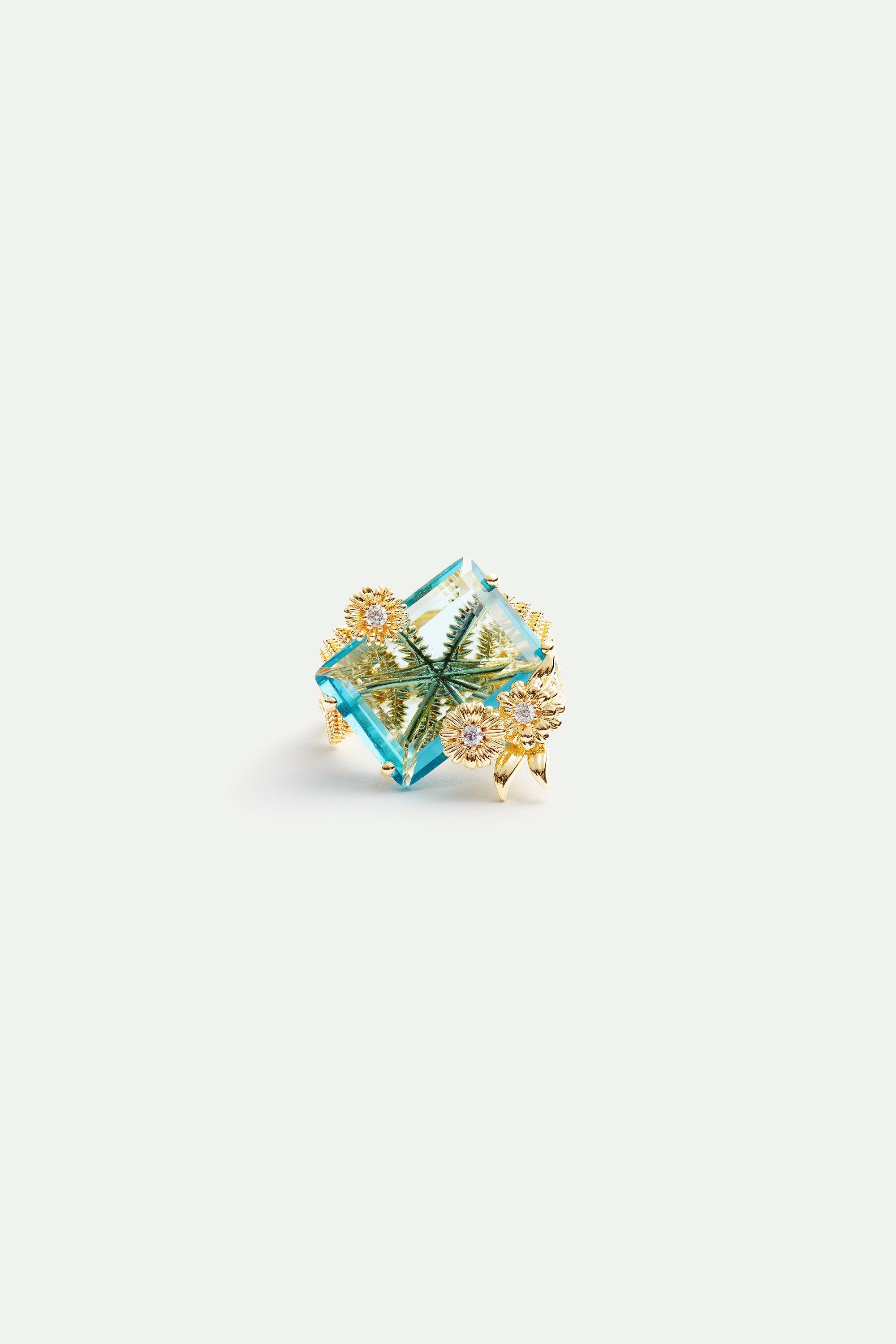 Blue cut stone and golden flower ring