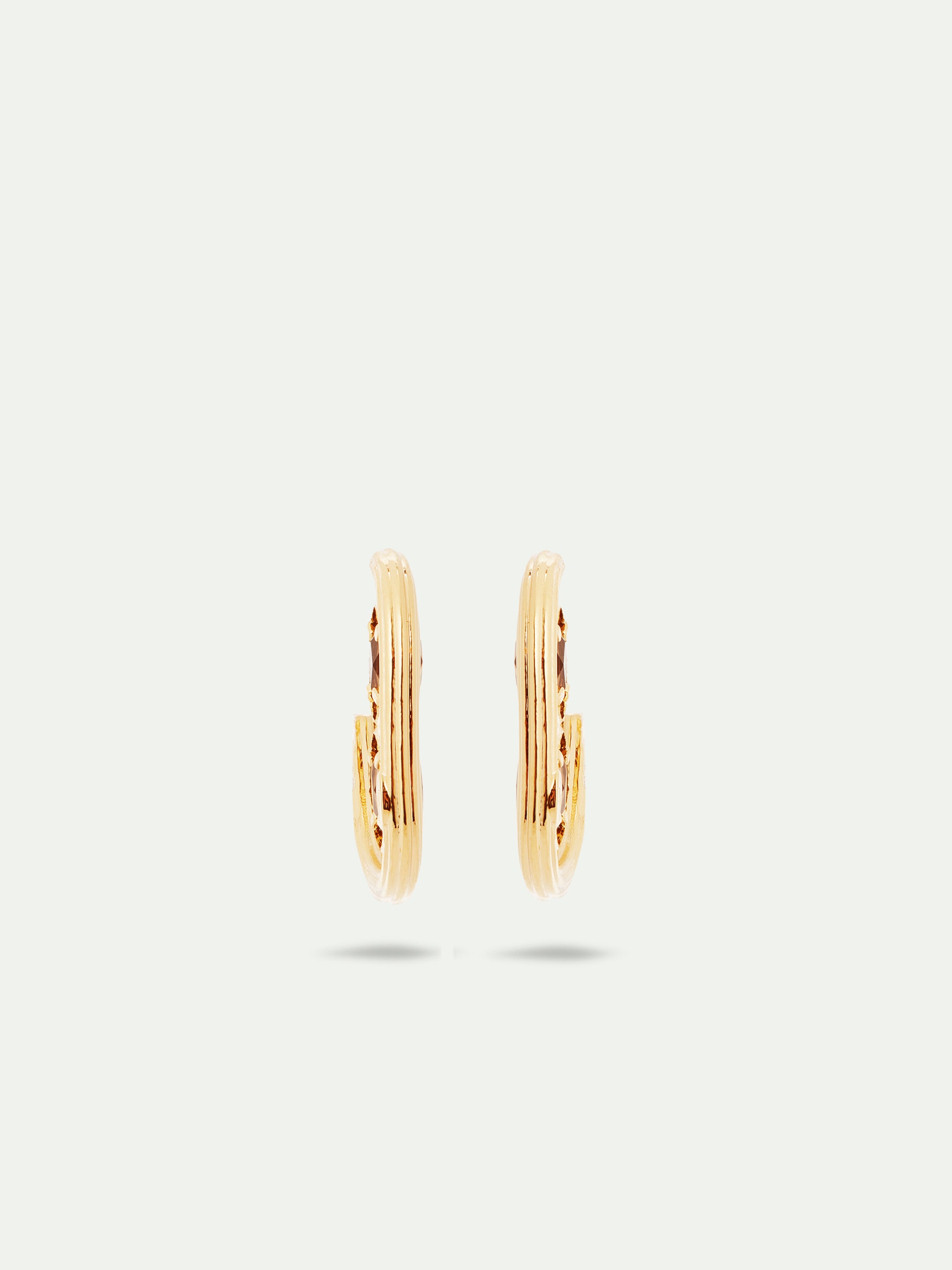 Gold hoop earrings and faceted glass