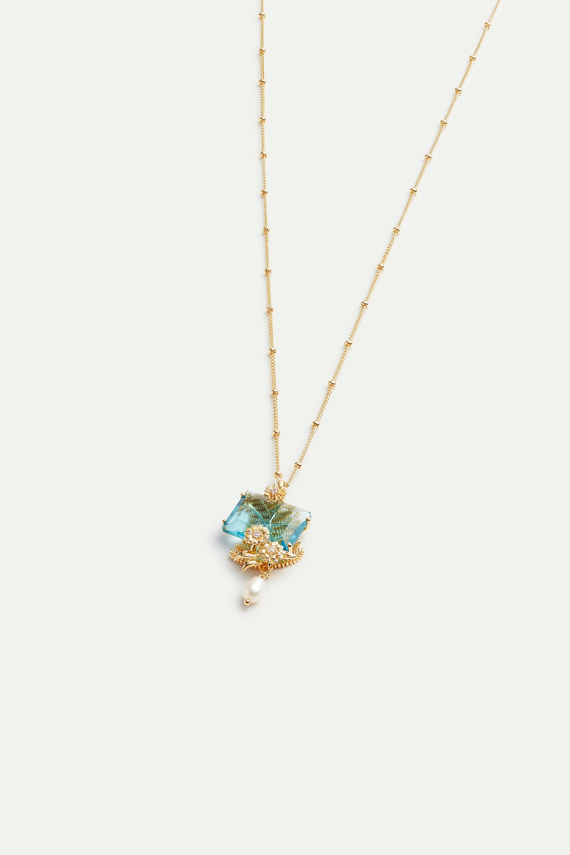 Blue cut stone, golden flowers and cultured pearl pendant necklace