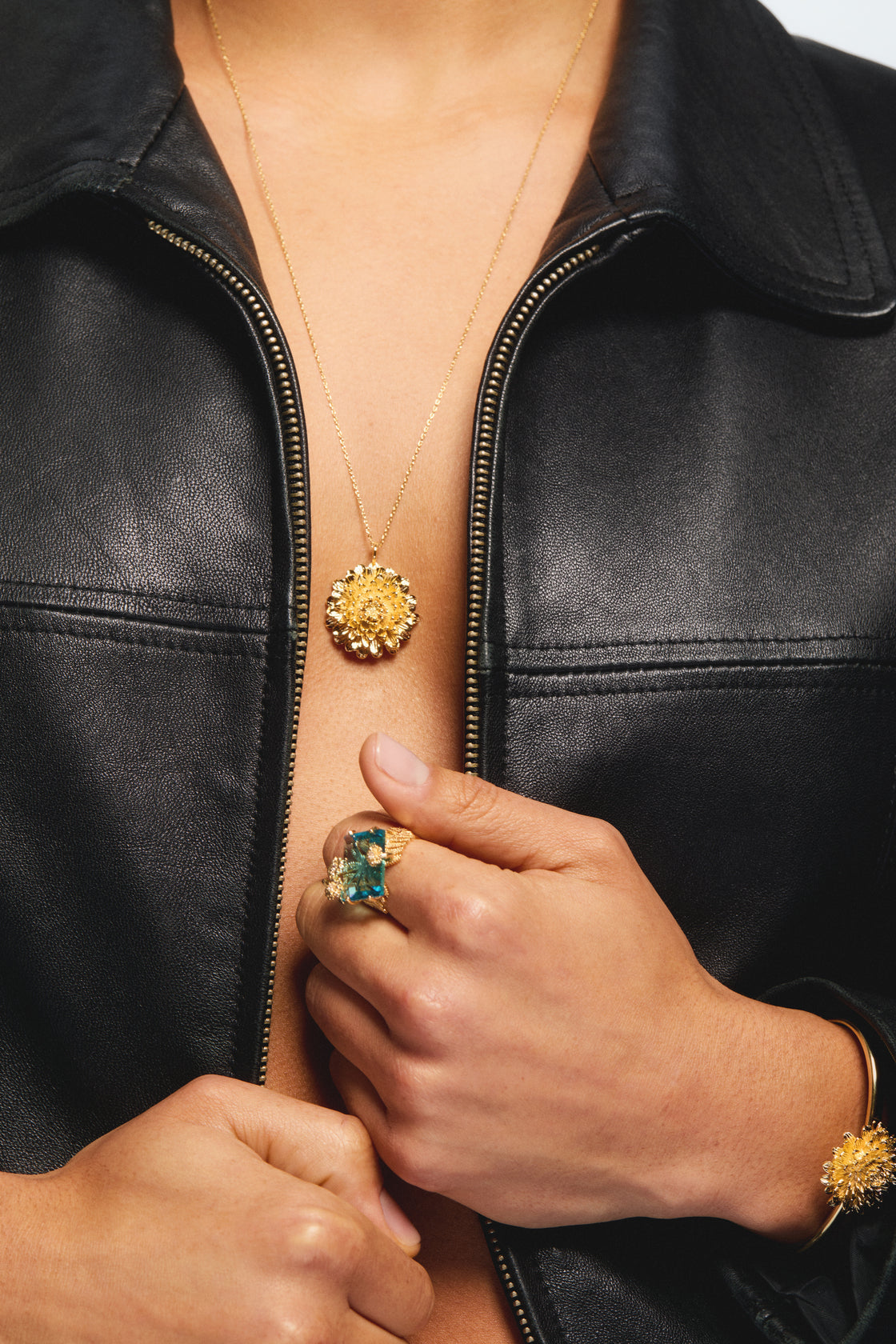 Blue cut stone and golden flower ring